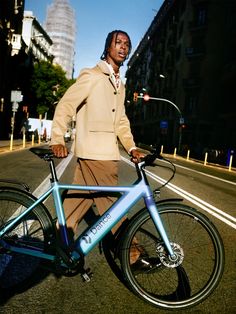 a man standing next to his bike on the street