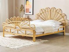 a bed that is made up with wicker and white linens on the floor