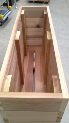 an unfinished wooden box is shown in the process of being built