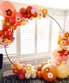 an arch made out of balloons and flowers