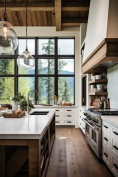 a large kitchen with lots of counter space and windows that look out onto the mountains