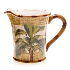 a brown and white pitcher with palm trees on it