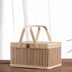 a wicker picnic basket on a wooden table