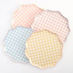 three pastel gingham plates on a white background