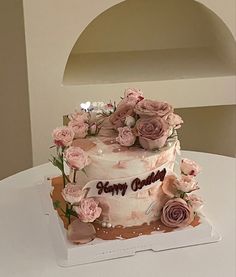 a three tiered cake decorated with pink flowers and the words sorry daddy on it