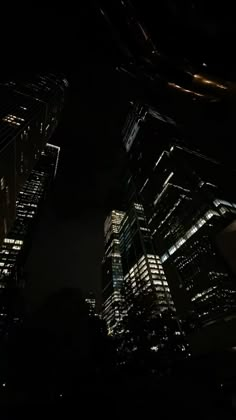 some very tall buildings lit up at night