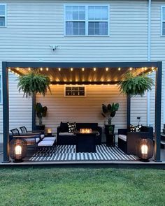 an outdoor living area with furniture and lights