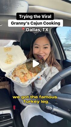 a woman holding a tray of food in her car