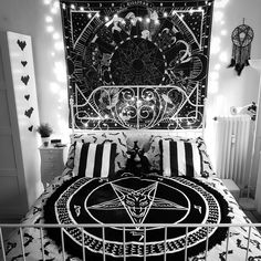 black and white photograph of a bed in a room with lights on the headboard