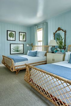 two beds in a room with blue walls