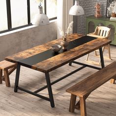 a wooden table with two benches next to it in front of a brick wall and windows