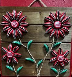 three red and green flowers on a wooden board