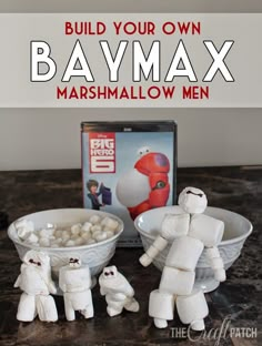 some toys are sitting on a table with the words build your own baymax marshmallow men