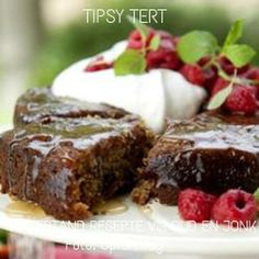 there is a chocolate cake with raspberries on the plate