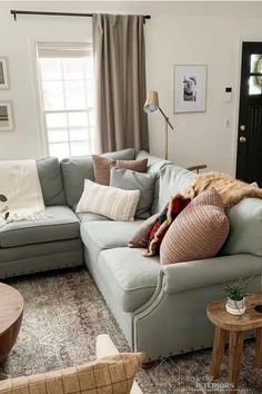 a living room filled with furniture and pillows