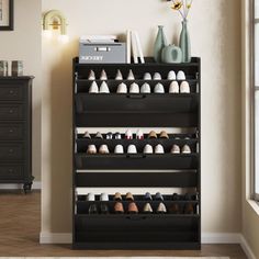 there is a shoe rack with many pairs of shoes on it in the corner of this room