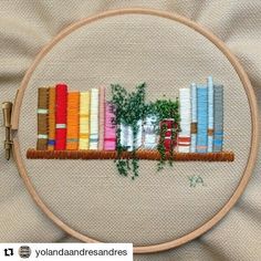 a cross stitch book shelf with books on it