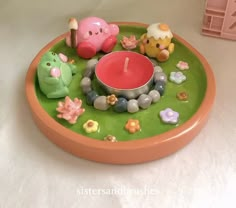 there is a candle and some toys on the trays that are in the shape of animals