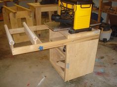 a workbench with tools on top of it in a room full of woodworking equipment