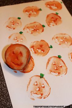 a piece of food that is sitting on top of a sheet of paper with faces drawn on it