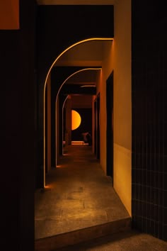 an empty hallway with lights on either side