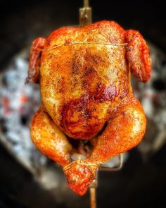 a cooked chicken sitting on top of a frying pan