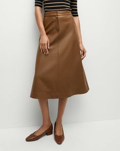 The classic A-line skirt, coated to look like leather. Equal parts polish and edge, this high-waisted midi skirt has a beautiful drape and movement with each step. Style the Louise with a silk top and kitten heels to play up the feminine factor.100% Polyurethane, 95% Coated Rayon, 5% ElastaneLining: 100% PolyesterDry clean onlyStyle #2411LT5130438 Brown A-line Skirt For Workwear, Brown A-line Winter Skirt, Brown A-line Pleated Lined Skirt, Leather Knee-length Lined Skirt, Sleek Knee-length Faux Leather Skirt, Thanksgiving Fashion, Navy And Khaki, Skirts Midi High Waisted, Merino Wool Sweater