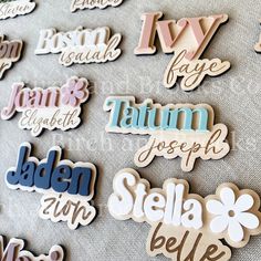 the name stickers are all different colors and sizes, including blue, pink, green,