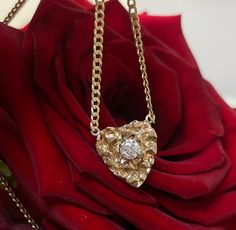 "14K Yellow Gold Nugget Heart with .30CT Natural Diamond on a Curb Chain Necklace The nugget heart is set with a single .30carat round brilliant cut diamond, VS clarity, F color. The pendant is 19x14mm, and the chain is 20\" long, and 2mm wide. The chain can be shorted by request. 6.5 grams in total." Gold Nugget Necklace, Yellow Gold Heart-shaped Jewelry With Rose Cut Diamonds, Yellow Gold Heart-shaped Rose Cut Diamond Jewelry, The Nugget, Nugget Necklace, Curb Chain Necklace, Gold Nugget, Dope Jewelry, Elastic Bracelet