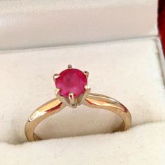 a ring with a pink stone in it