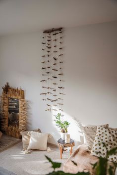 a living room filled with lots of furniture next to a fire place and plant on the wall