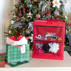 the christmas tree is decorated with red and green ribbons, scissors, bows, and other holiday decorations