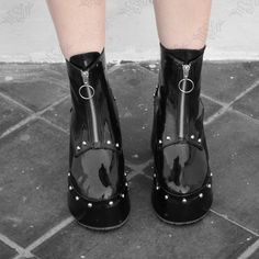 Step into edgy elegance with our Noir Platform Boots from the original Hesed Blackout collection.  Handcrafted by Salvadoran artisans, these round-toe ankle boots feature a 9cm heel at the back and 4cm platform at the front. Made from high-quality black faux patent leather, including a sole lining. Adorned with silver rivets, they open with a ring pull zipper. Customize colors and sizes. Perfect for casual outings, cosplay, or striking photo shoots. Please note that this product is shipped from Punk Platform Boots With Grommets, Punk Platform Boots With Grommets For Alternative Fashion, Gothic Platform Boots With Grommets, Edgy Platform Boots With Grommets For Concerts, Edgy Grommet Platform Boots For Concerts, Edgy Grommeted Platform Boots For Concerts, Punk Style Platform Boots With Studded Outsoles For Streetwear, Black Platform Boots With Rivets For Alternative Fashion, Emo Leather Moto Boots