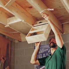 a man is working on the underside of a ceiling with plywood planks attached to it