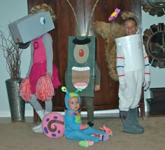 three children in costumes standing next to each other