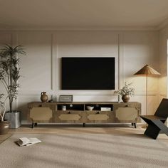 a living room filled with furniture and a flat screen tv on top of a wall