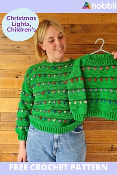 a woman wearing a green christmas sweater holding up a crochet pattern for the top