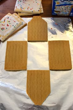 four cookies are arranged on top of a sheet of tin foil