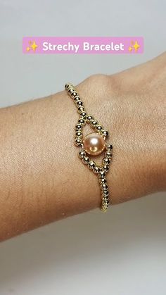 a woman's arm with a bracelet on it and a pearl beaded bracelet