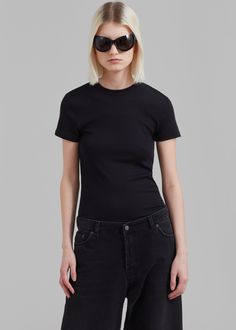 Color: Black Lightweight ribbed knit with stretch Relaxed fit Waist length Crew neckline Slip-on style Unlined 63% Polyester 33% Rayon 4% Spandex Dry Clean By The Frankie Shop. Imported Sporty Washed Black T-shirt With Relaxed Fit, Black Ribbed T-shirt Relaxed Fit, Black Ribbed Relaxed Fit T-shirt, Black Cotton T-shirt With Contrast Trim, Boxy Fit Washed Black Cotton T-shirt, Waist Length, Black Tee, Ribbed Knit, Slip On