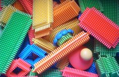 many different colored plastic toys in a pile