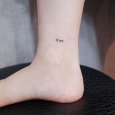 a small tattoo on the ankle saying love