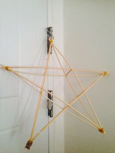 a star made out of sticks is hanging on the door