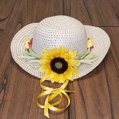 This handmade, custom designed straw hat is perfect for this Spring/Summer. Now that Stay at Home orders are lifted, they are just waiting for beach strolls and dinner parties. Features: 22.5", 3" Brim that narrows in the back Natural Straw Faux SunFlower & Stems Yellow Ribbon Ethnic Beading Note: Model is 5 years old (21" head circumference). Handmade Country Straw Hat For Spring, Handmade Straw Hat For Summer Country Events, Handmade Straw Hat For Country Events In Spring, Handmade Straw Hat For Spring Country Events, Handmade Country Style Sun Hat For Summer, Handmade Summer Hats For Country Events, Adjustable Straw Hat For Picnic And Beach Season, Adjustable Straw Hat For Beach Season Picnic, Adjustable Straw Hat For Beach Picnics