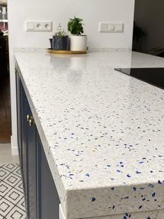 a counter top with blue and white speckles on it in a home kitchen