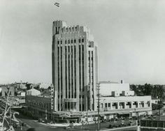 an old black and white photo of a tall building