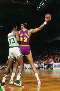 two basketball players in action on the court