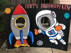 a birthday sign with an astronaut and rocket on it