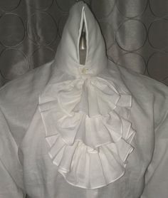 Here we have combined an 18th Century Collar and Neck Ruffles with a modern fit body in an excellent 100% linen. Made with a modern fit body for comfort, with real mother of pearl shell buttons Extra high collar is sculpted in back, for easy wear Shoulder yoke has a pleat at center back Cuffs can be folded back for French cuff effect, or left down for the Poet's sleeve look. Order by Neck, chest and sleeve measurements Elegant Formal Linen Tops, Fitted White Shirt With Ruffled Collar, White Formal Shirt With Ruffled Collar, White Fitted Shirt With Ruffled Collar, Elegant White Shirt With Ruffled Collar, Elegant Linen Tops With Buttons, Elegant White Linen Top, White Linen Top For Formal Occasions, Elegant Fitted Linen Blouse