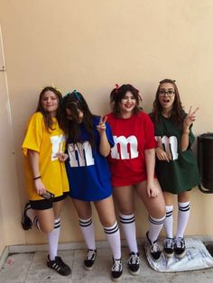 four girls in matching outfits posing for the camera